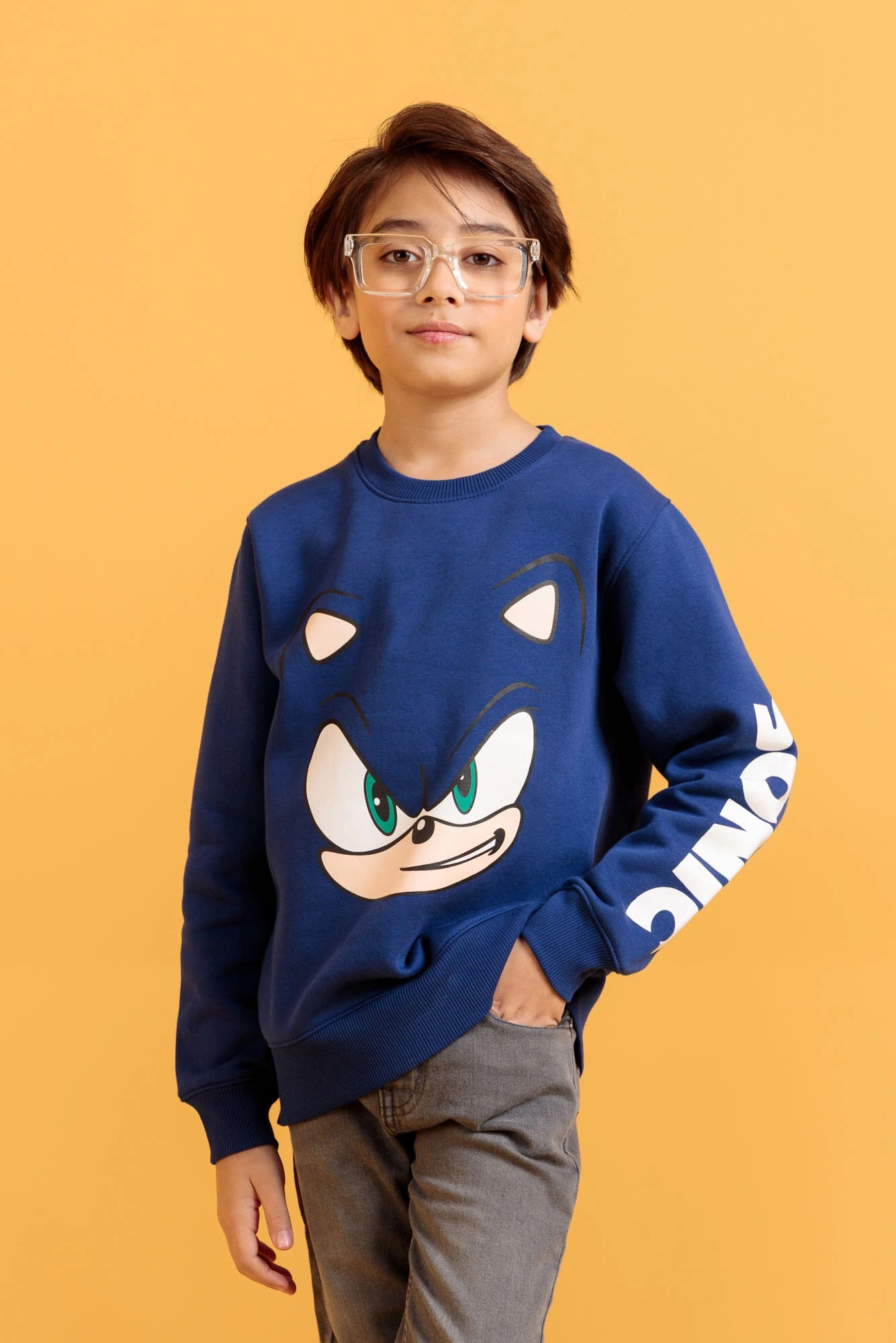 Junior boy wearing a sweatshirt in Palace Blue with screen print