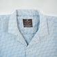Light blue patterned shirt with a brand label