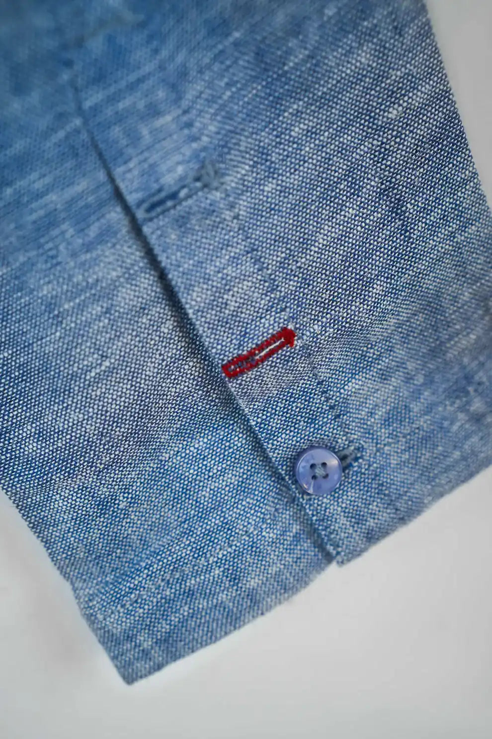 Light blue shirt cuff close-up with contrast stitching
