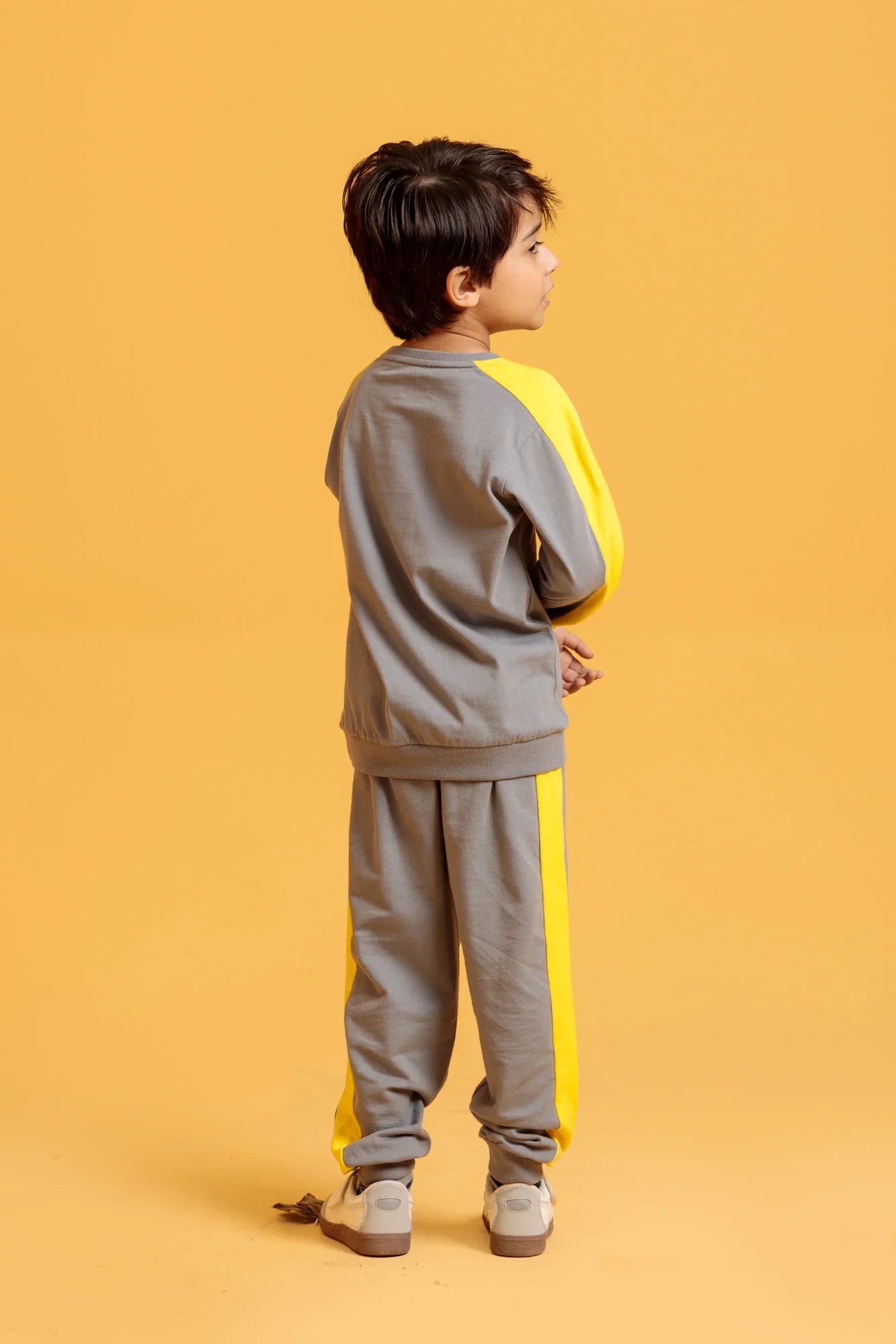 Little Boy wearing neutral grey two-piece outfit