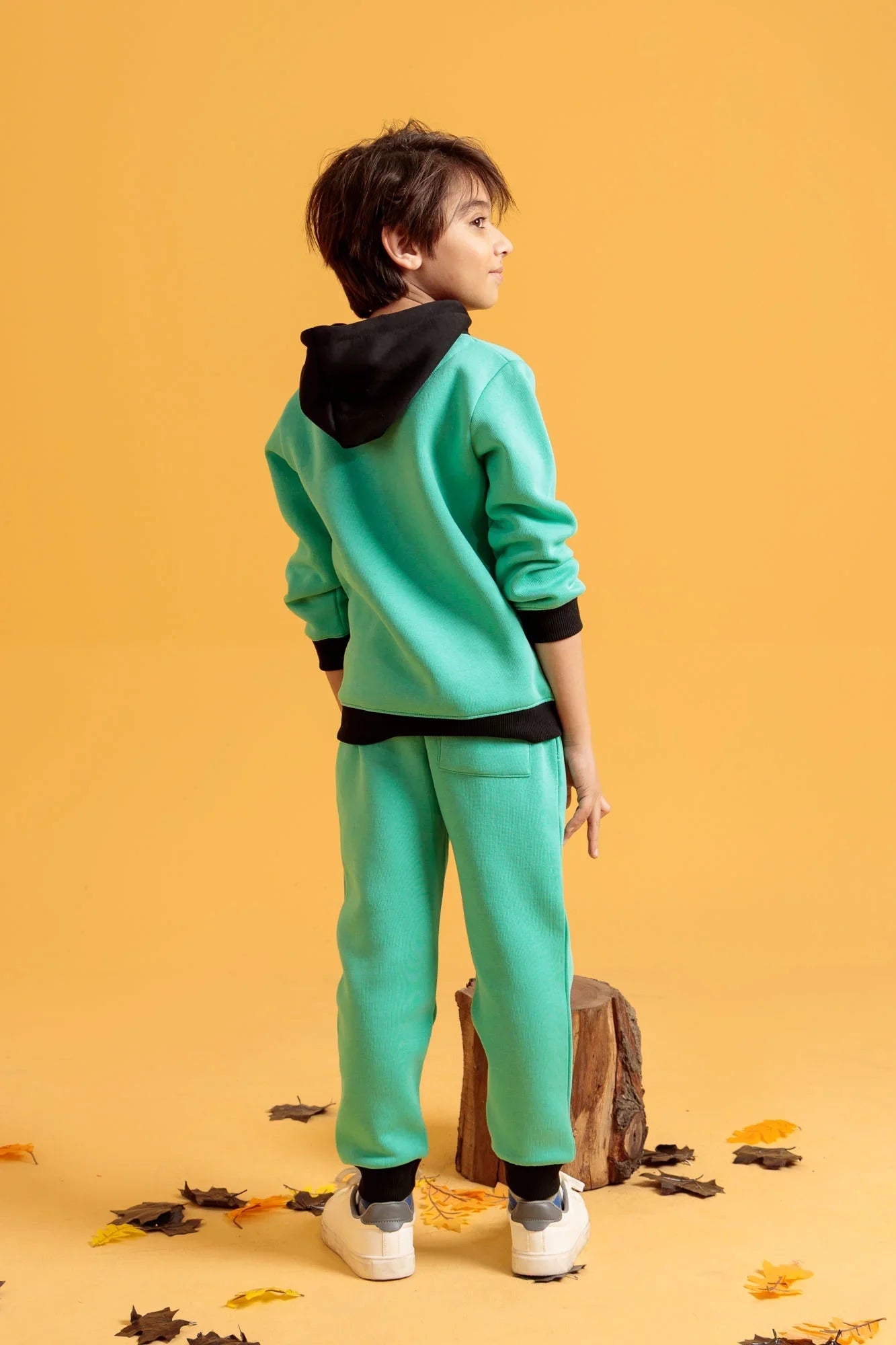 Little boy wearing aqua green outfit 