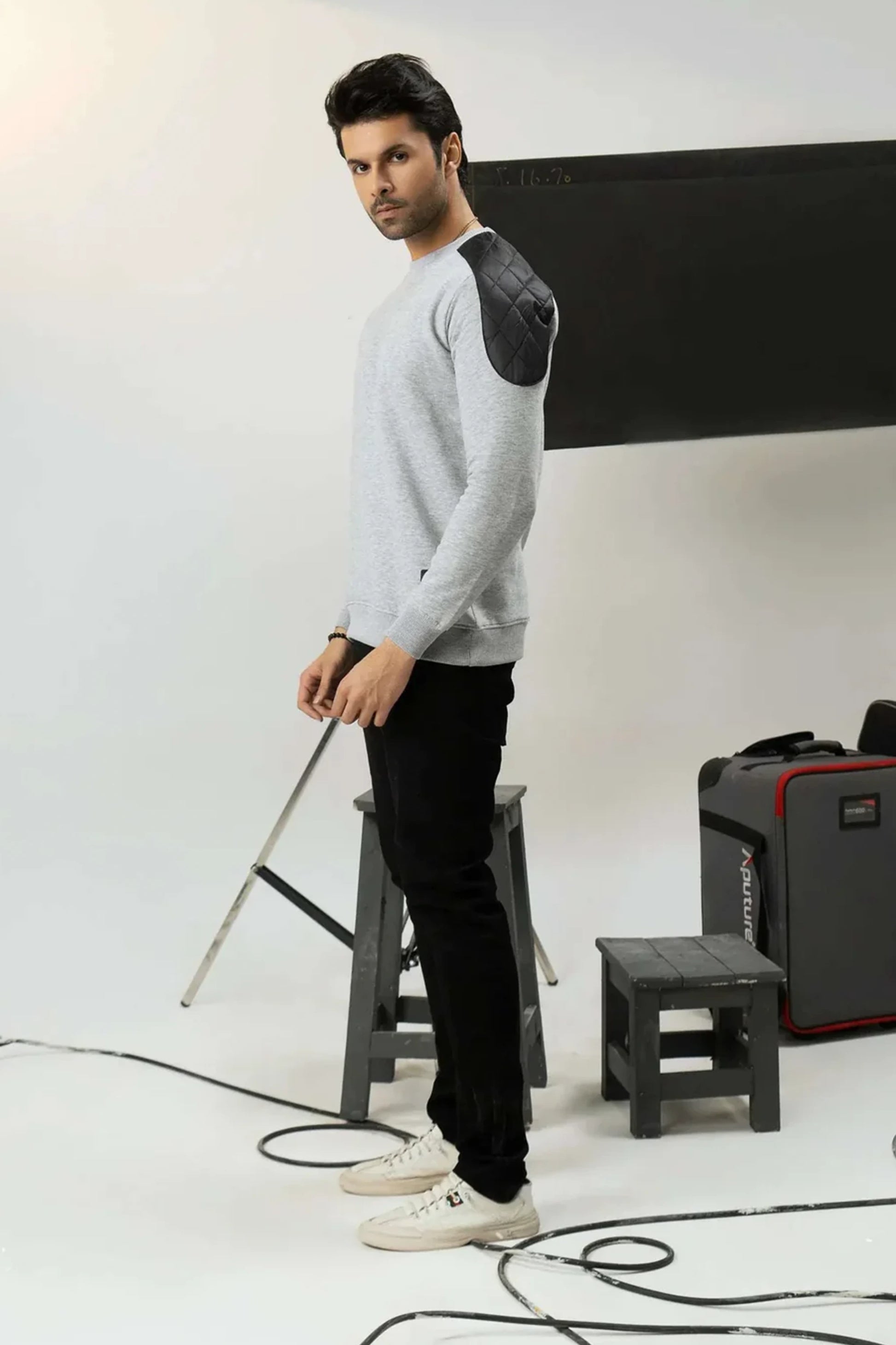 A man in a studio setting with photography equipment
