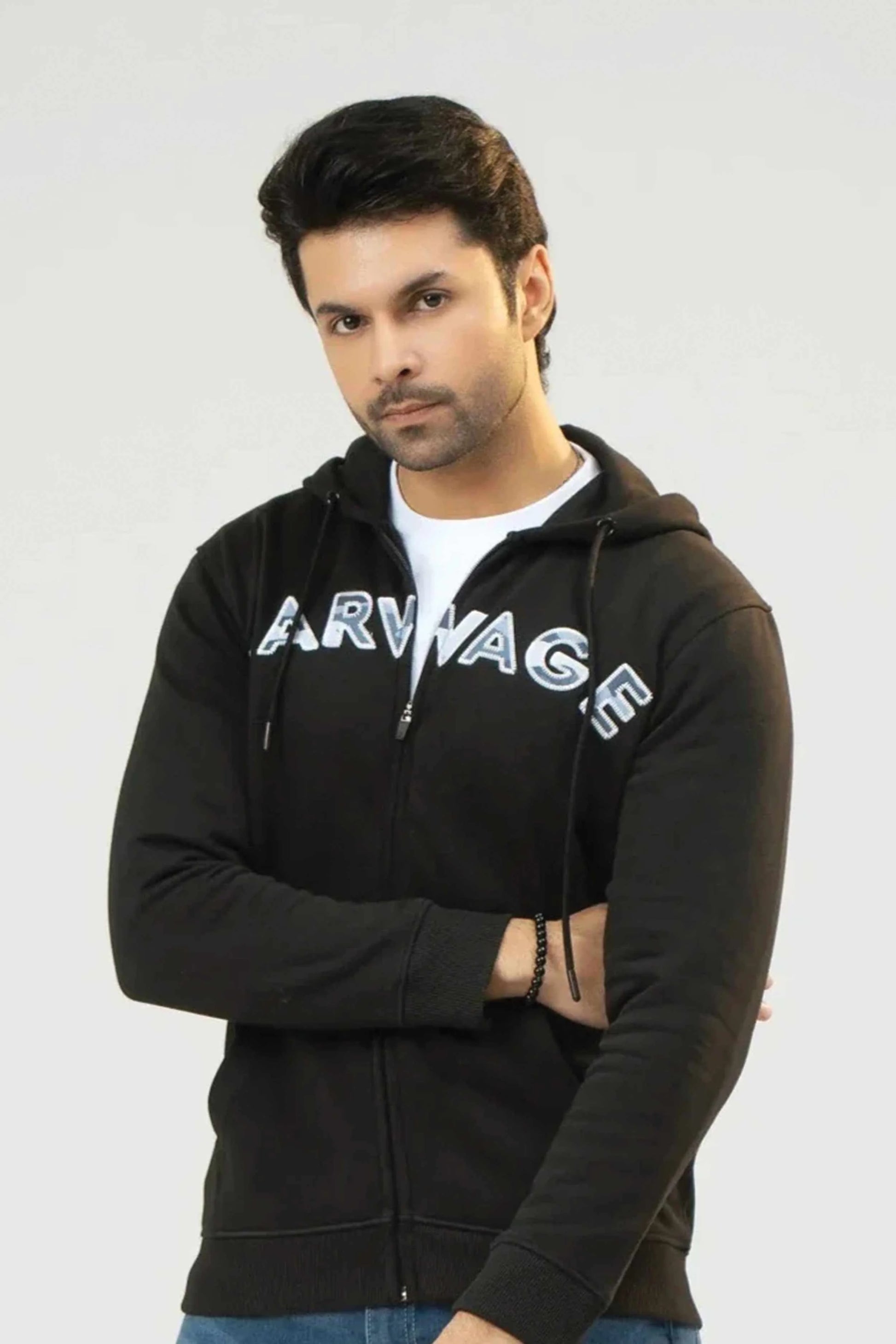 Man wearing a black hoodie with 'Arwage' branding on a white background