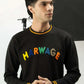 Man wearing a black regular fit sweatshirt  with colorful text in a studio setting