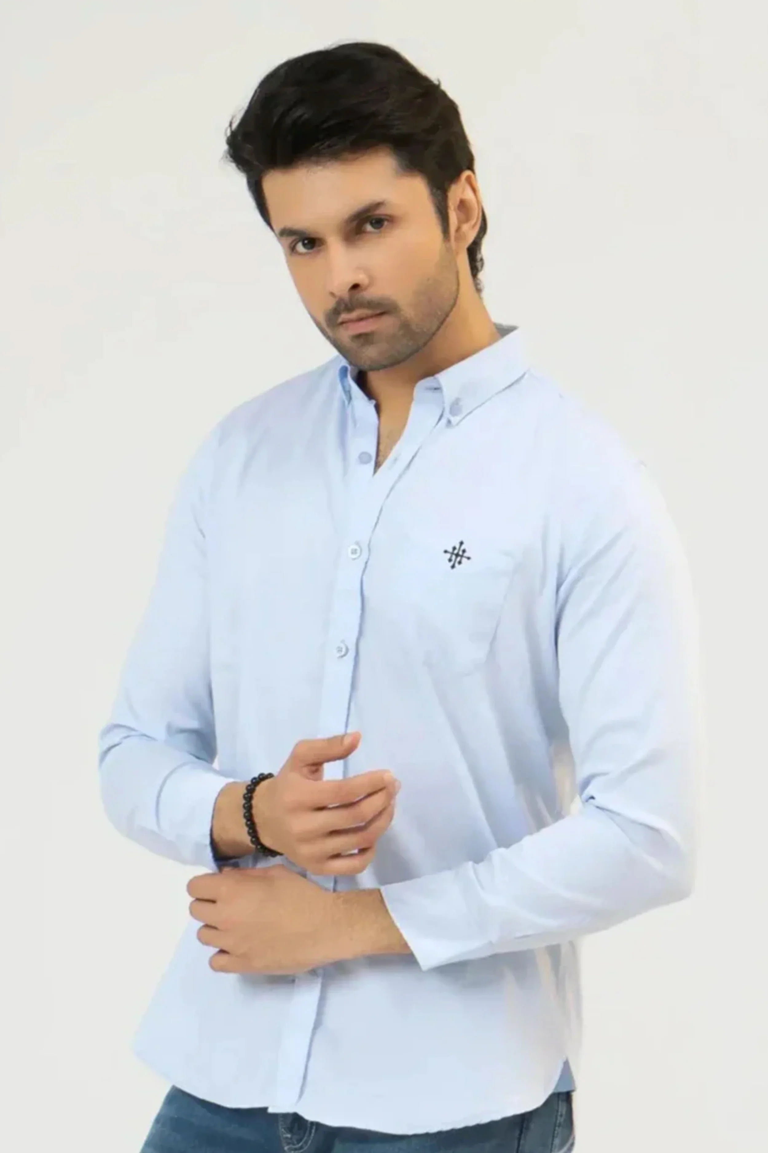 Man wearing a clear sky casual shirt on a white background