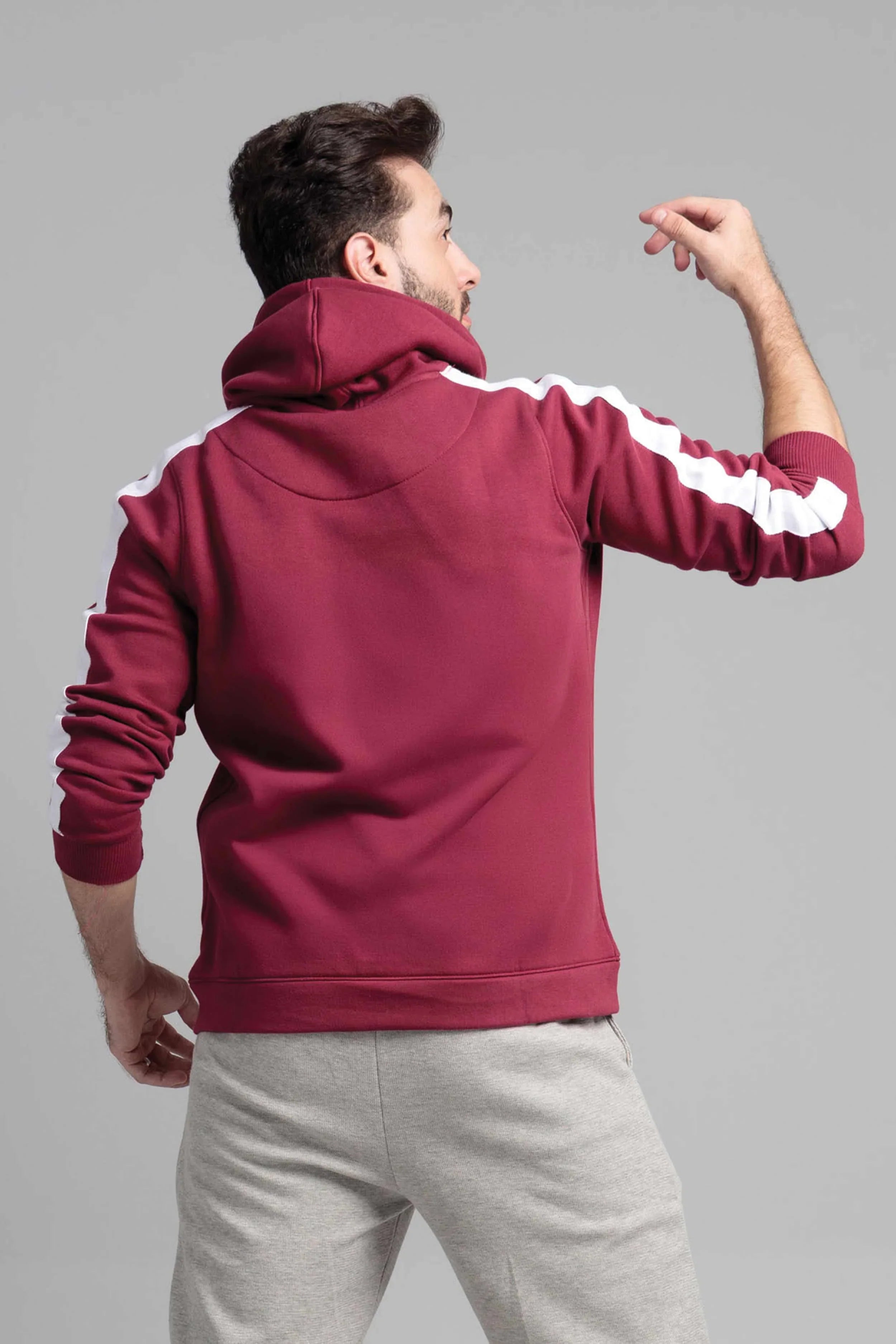 Man wearing a maroon hoodie with white stripes
