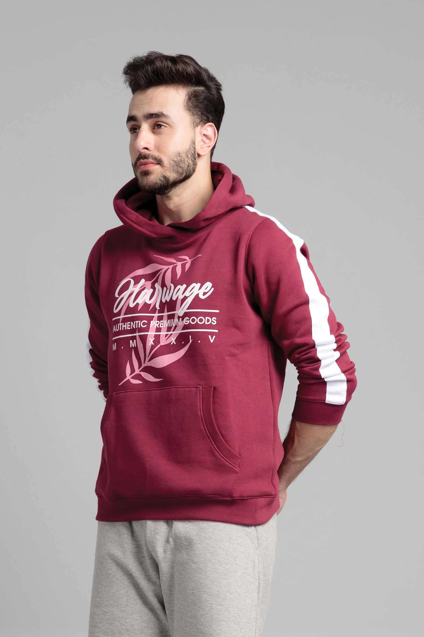 Man wearing a maroon hoodie with white text and accents on a gray background
