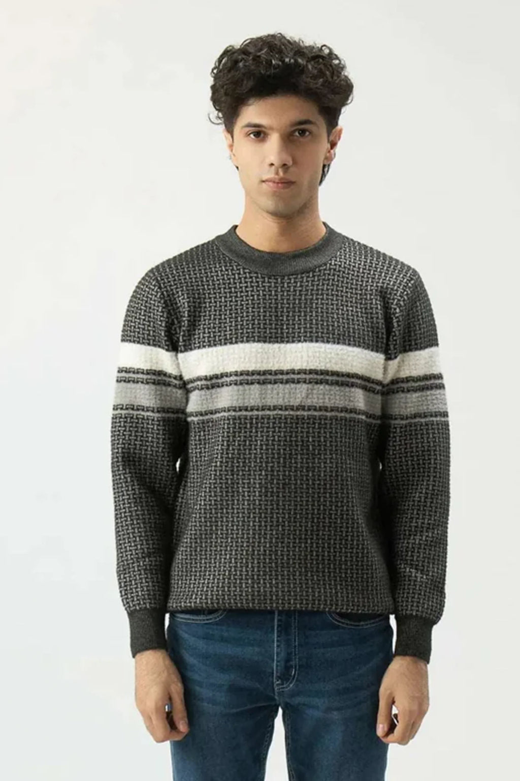 Man wearing a patterned sweater with horizontal stripes on a white background