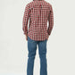 Man wearing a red and white checkered shirt and blue jeans