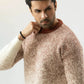 Man wearing a textured sweater against a plain background