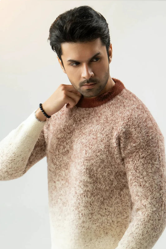 Man wearing a textured sweater against a plain background