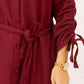 Maroon dress with long sleeves and a belt