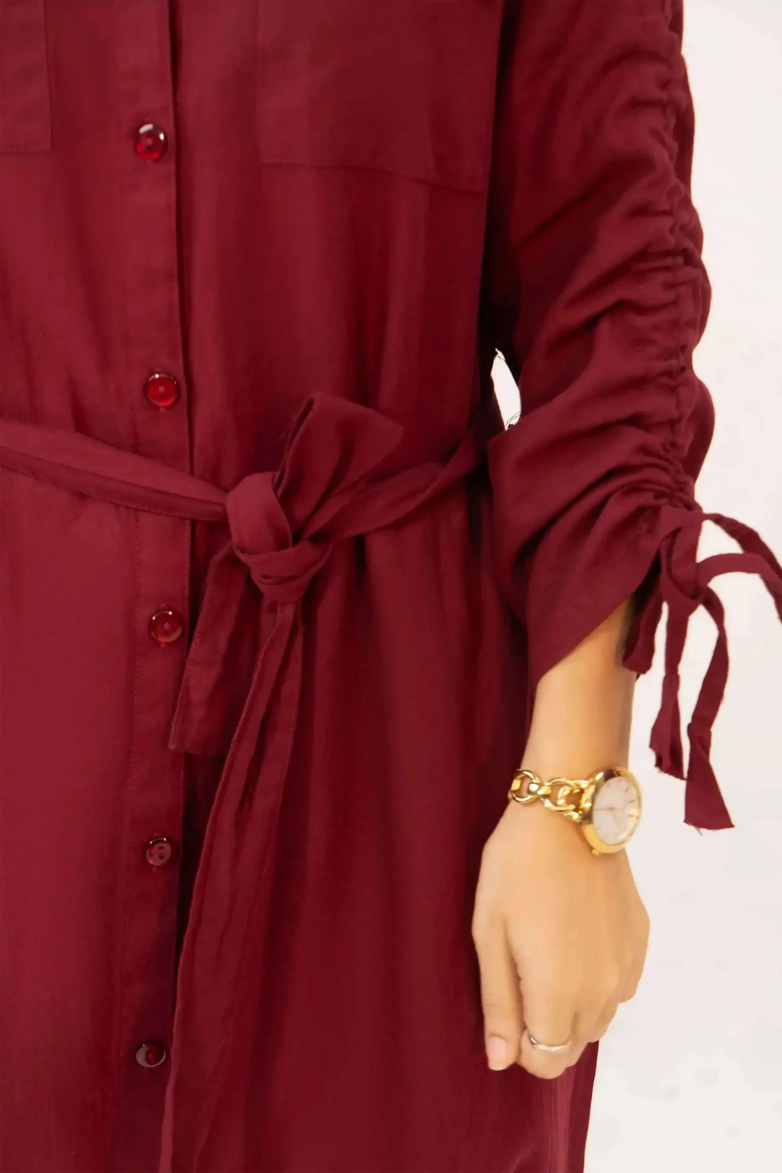 Maroon dress with long sleeves and a belt