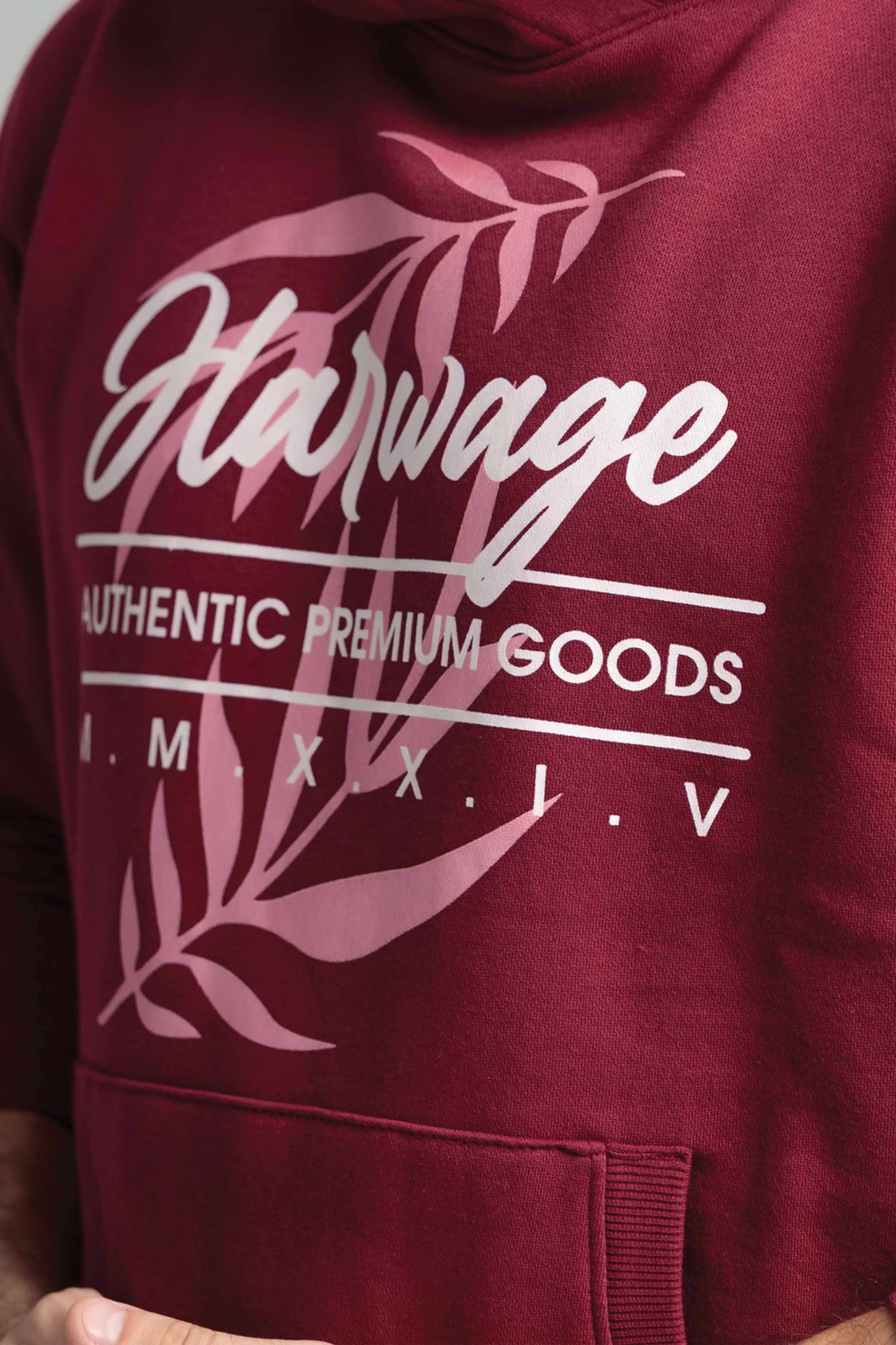Maroon hoodie with 'Harvage' branding and leaf design on a plain background