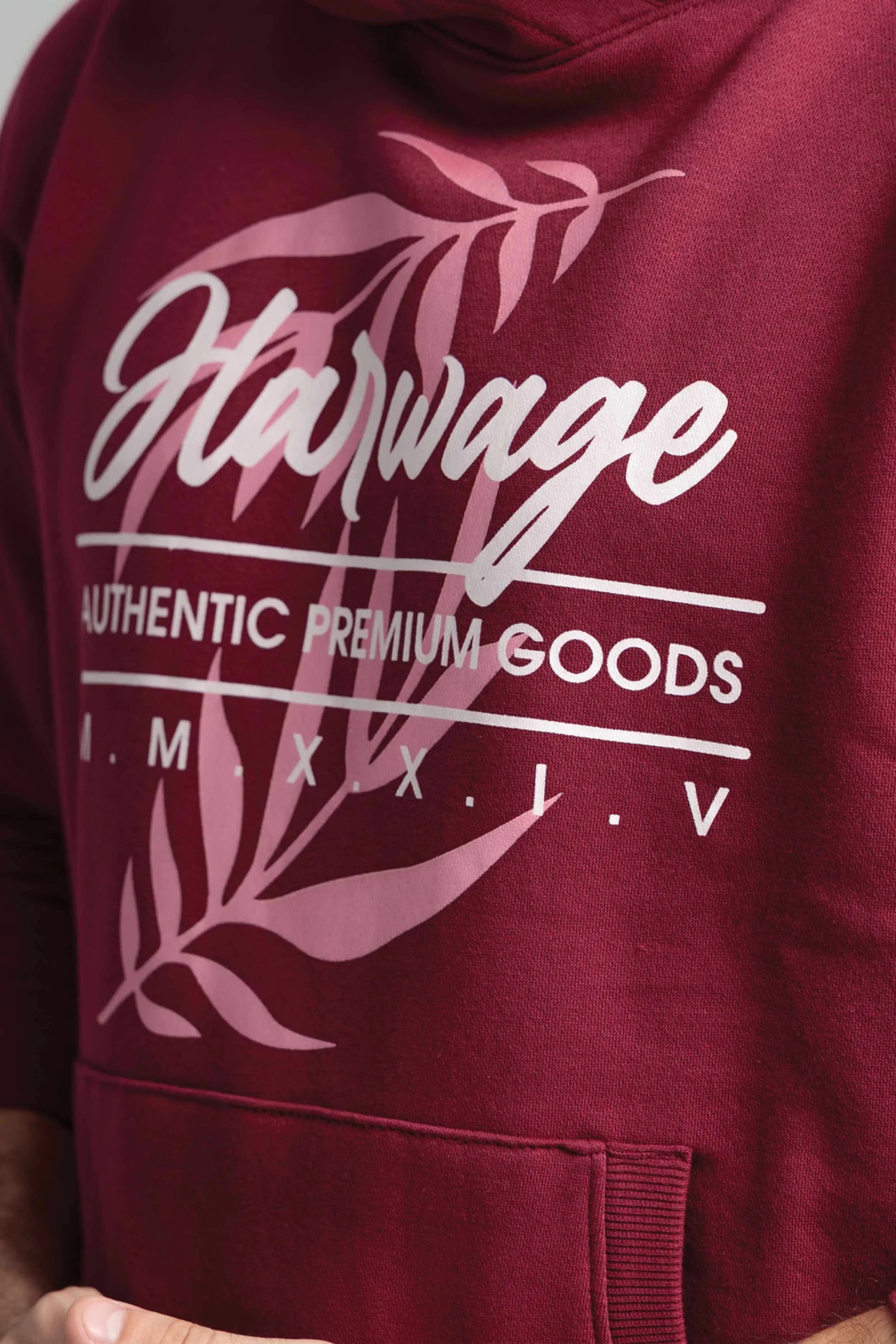 Maroon hoodie with 'Harvage' branding and leaf design on a plain background