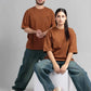 A man and woman wearing matching brown t-shirts and jeans