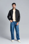 Men’s Black Wind Breaker Jacket paired with a beige t-shirt, blue jeans, and white sneakers