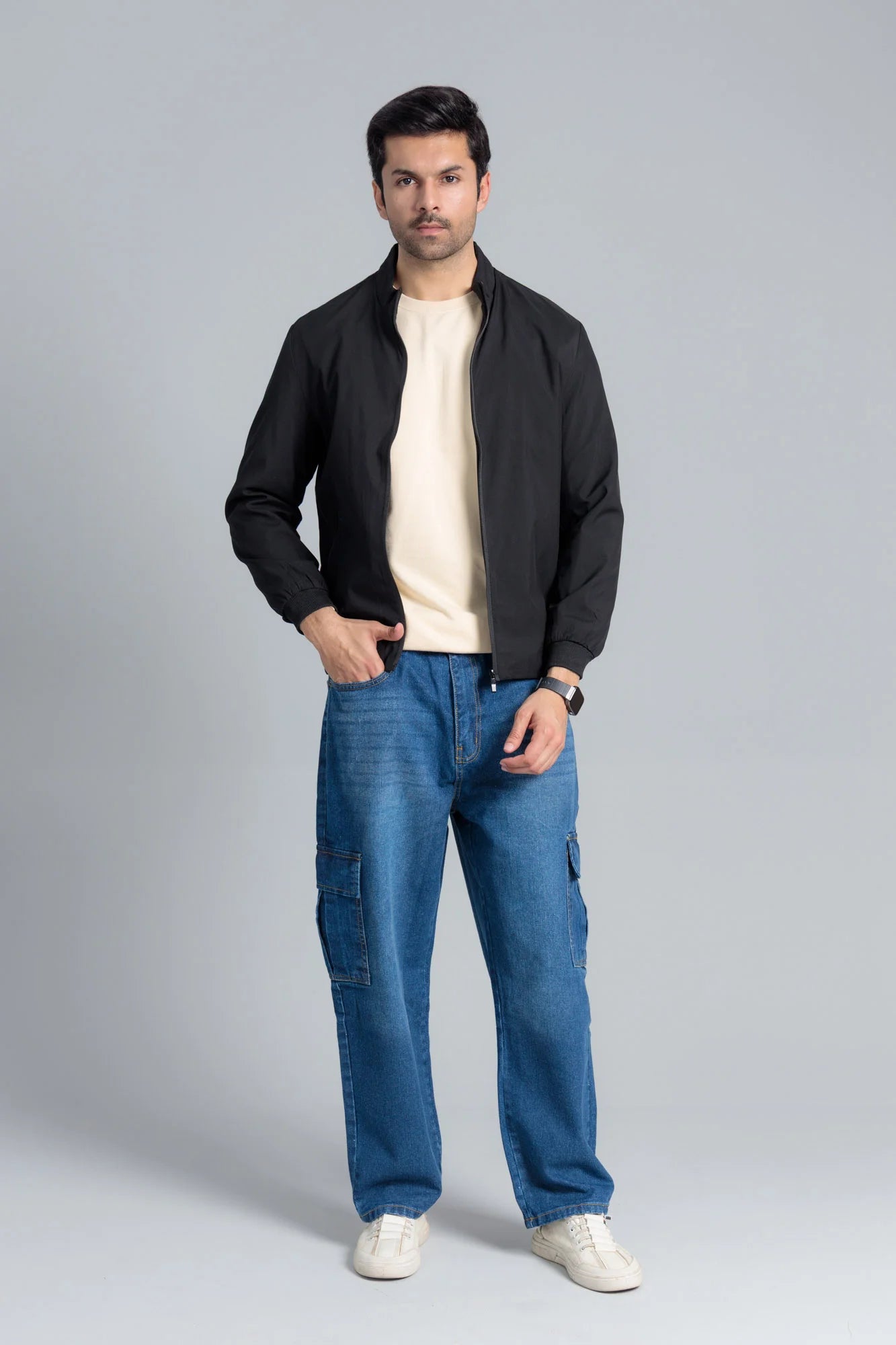 Men’s Black Wind Breaker Jacket paired with a beige t-shirt, blue jeans, and white sneakers