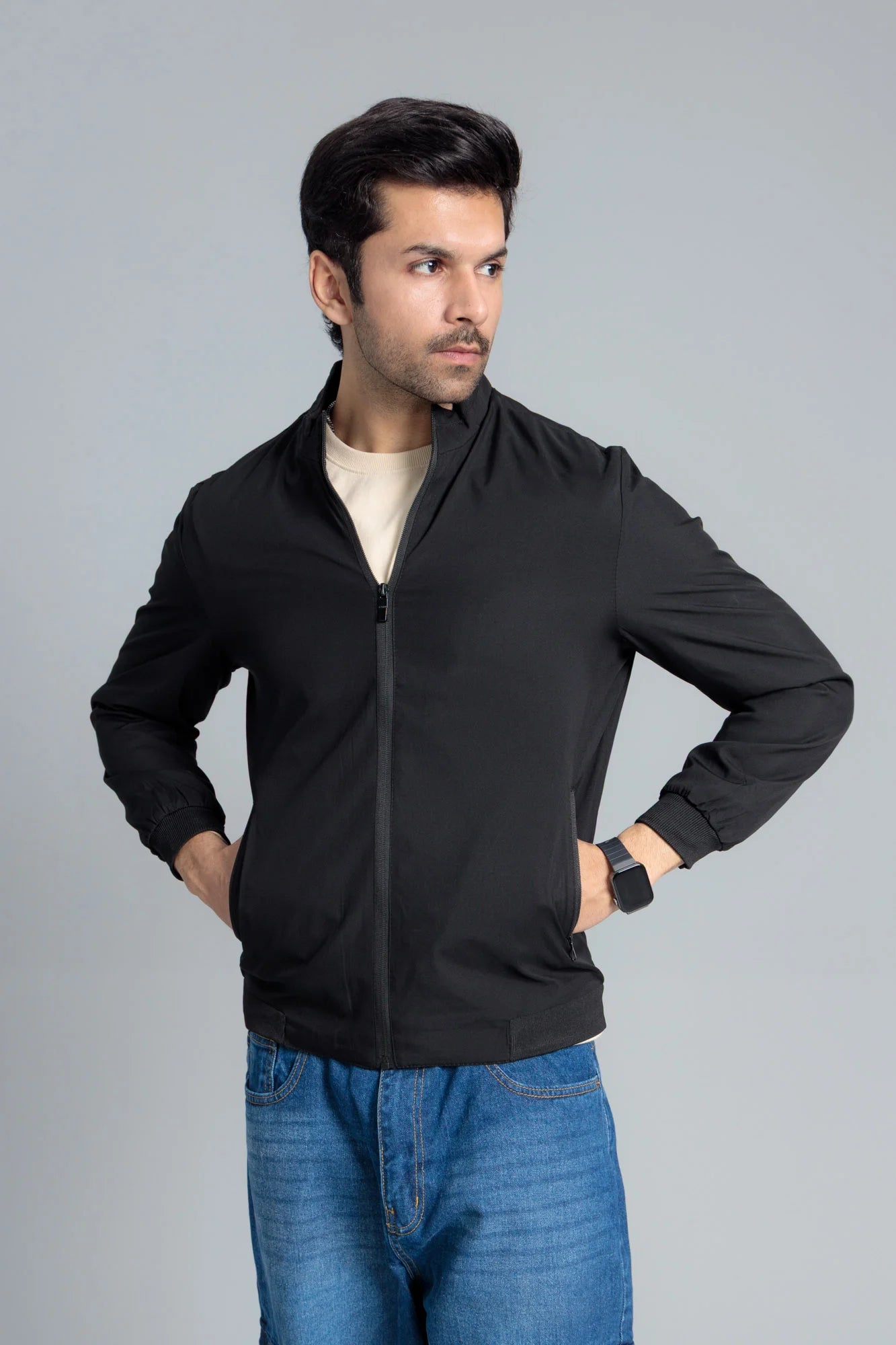 Men’s Black Wind Breaker Jacket unzipped, worn over a beige t-shirt and paired with blue jeans
