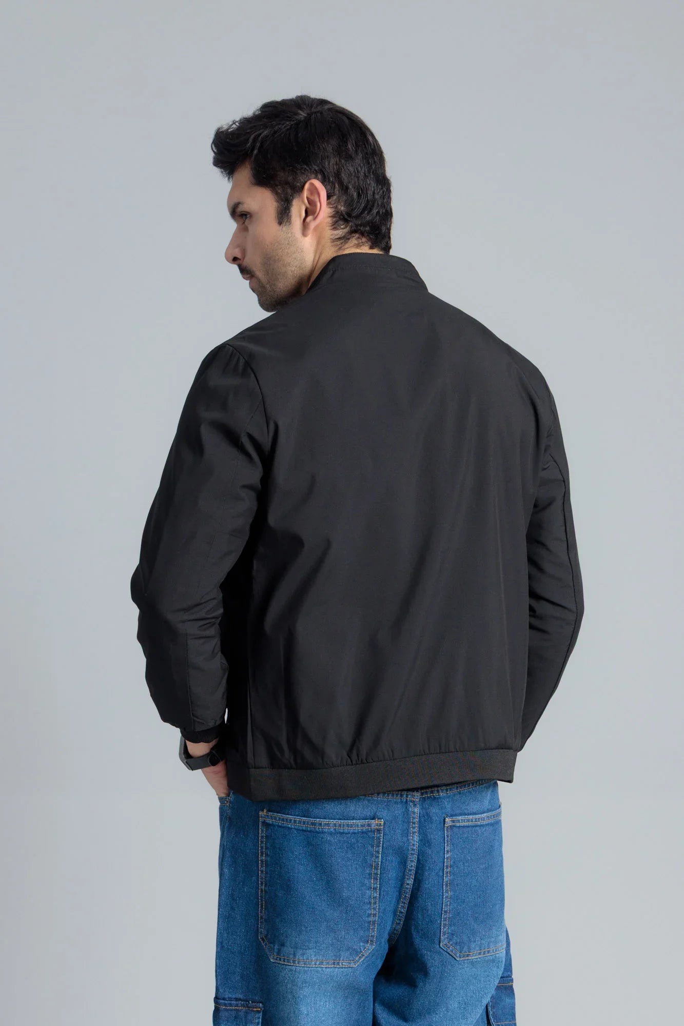Men’s Black Wind Breaker Jacket viewed from the back, paired with blue jeans
