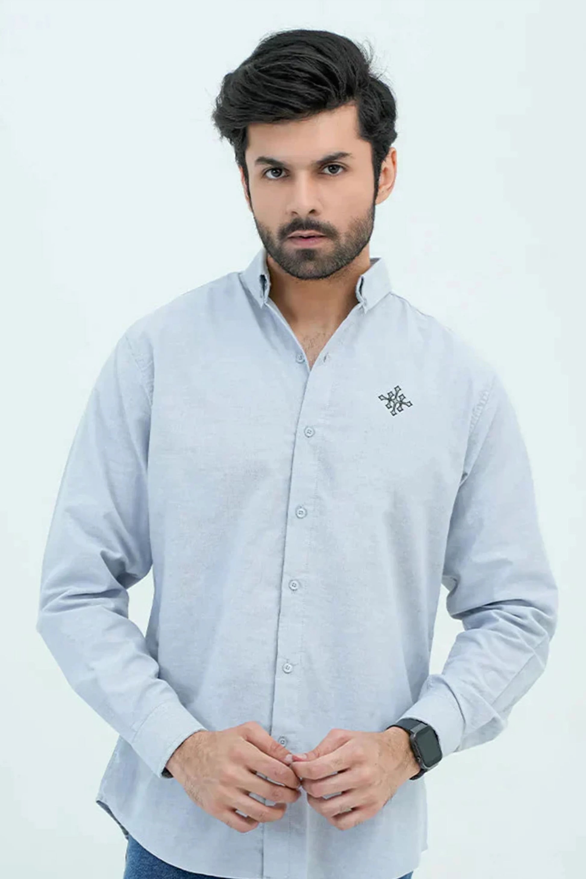 Man wearing a light blue Oxford shirt front view