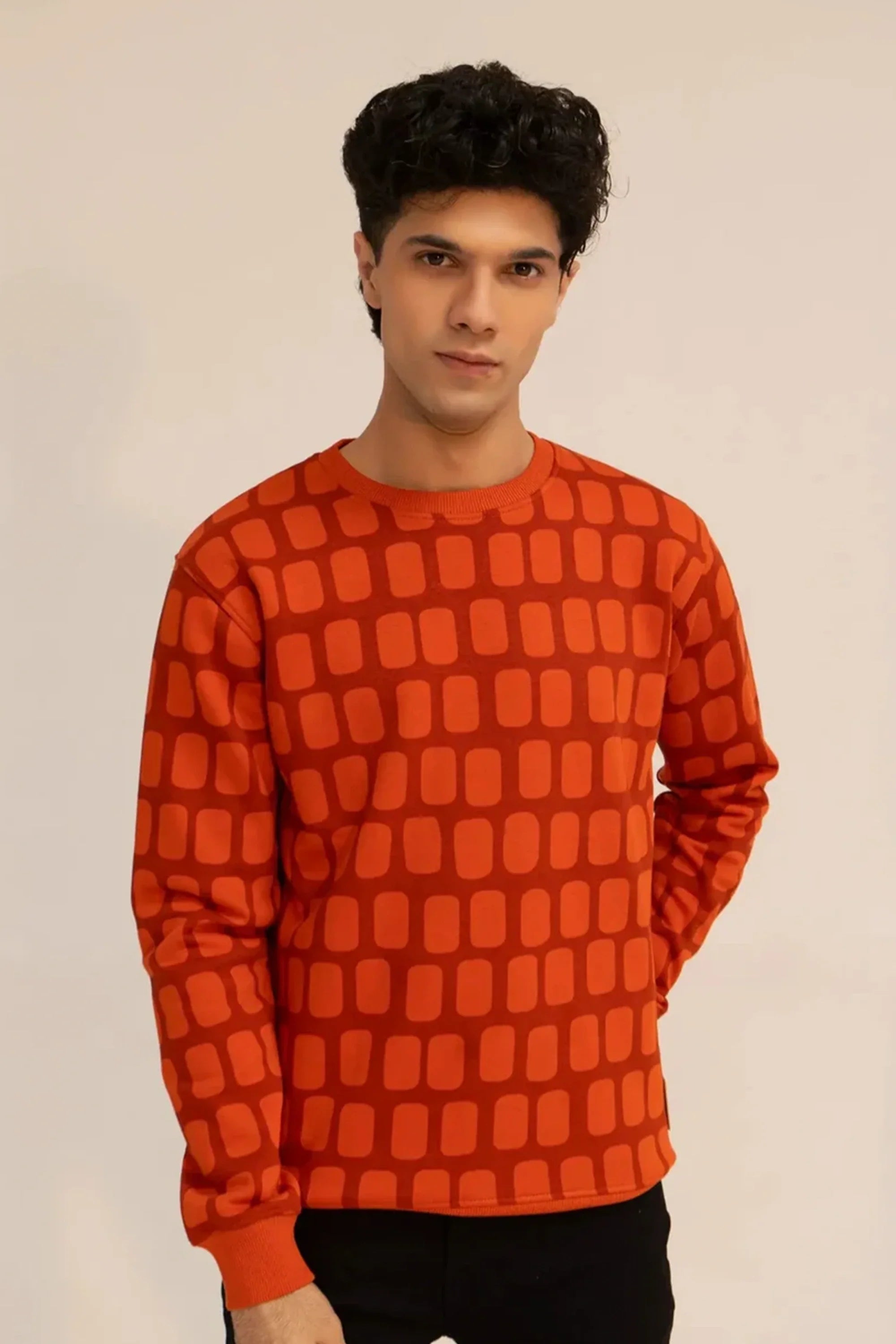 Men wearing a red geometric-patterned sweatshirt with long sleeves