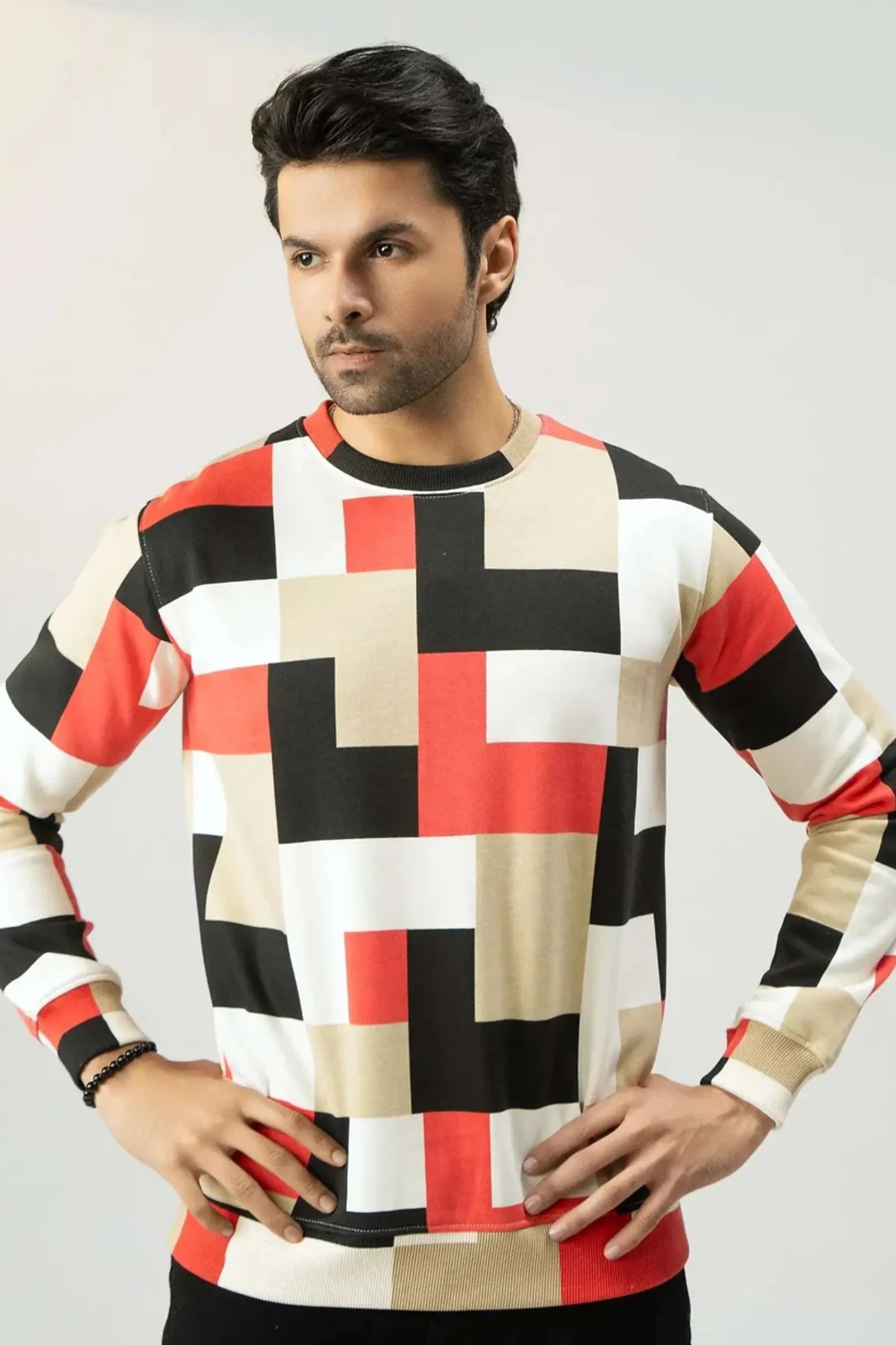 Model posing hands in a modern checkered sweatshirt