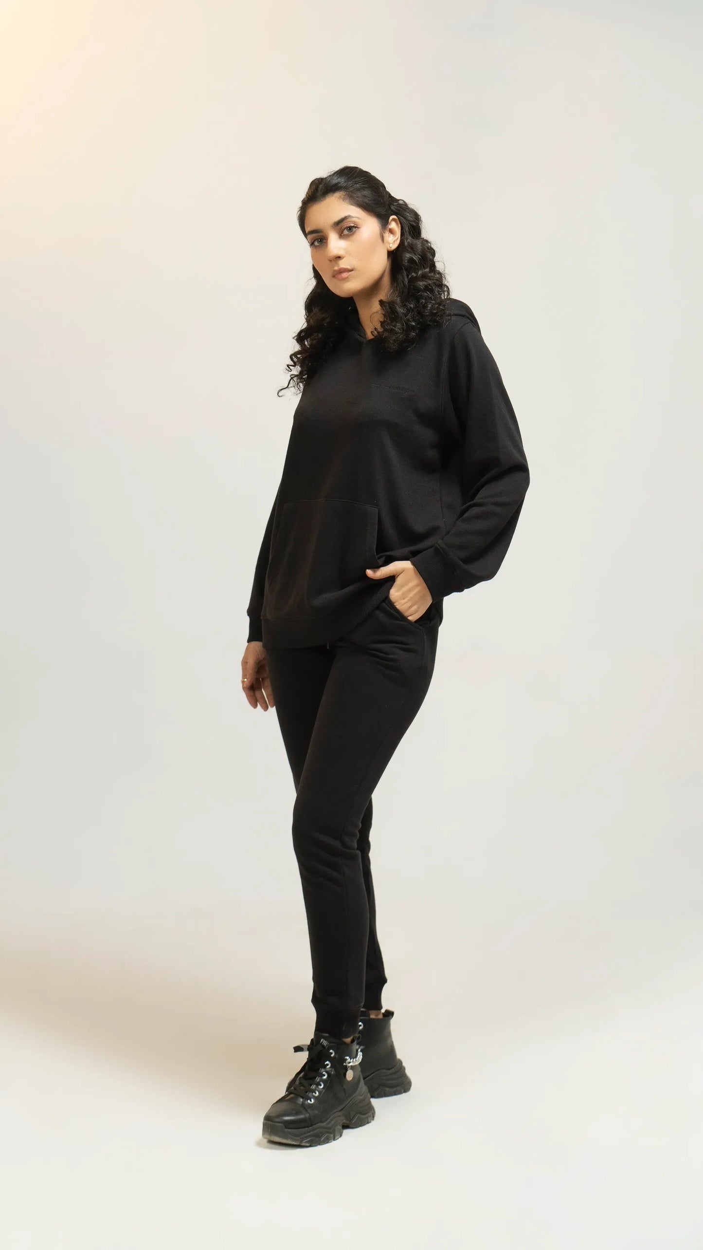  Model wearing a black regular tracksuit 