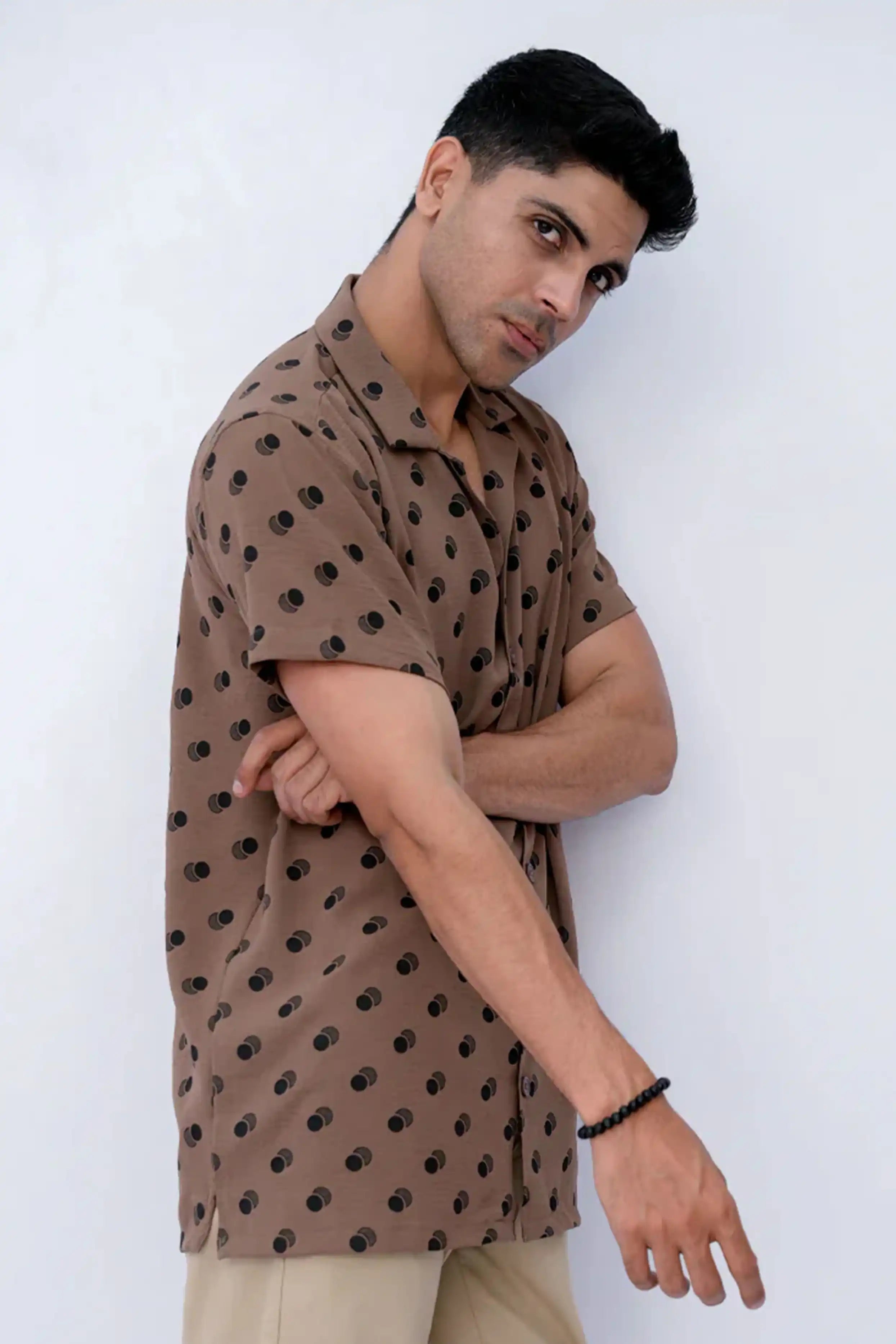 Model wearing a brown shirt with black patterns