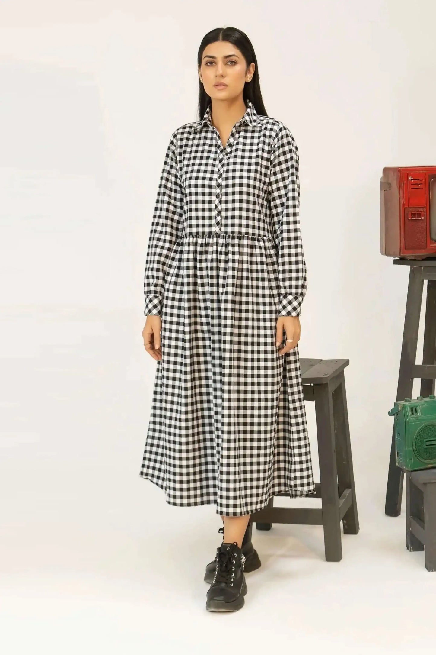 Model wearing a black and white checkered dress