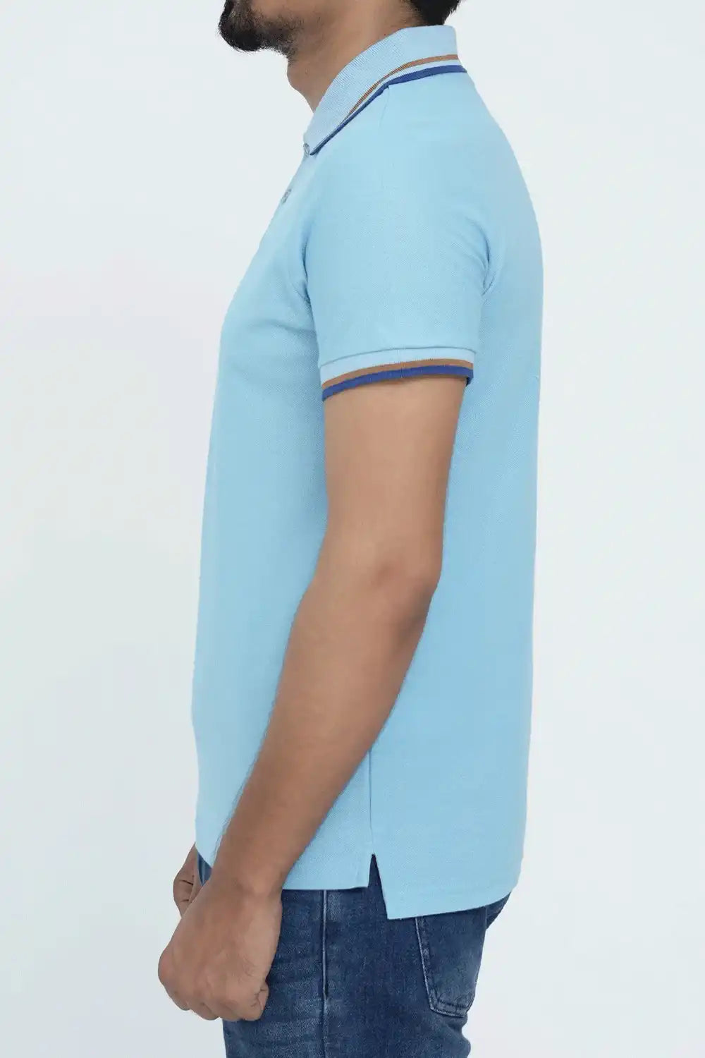 Person wearing a light blue polo shirt with dark blue trim on a white background