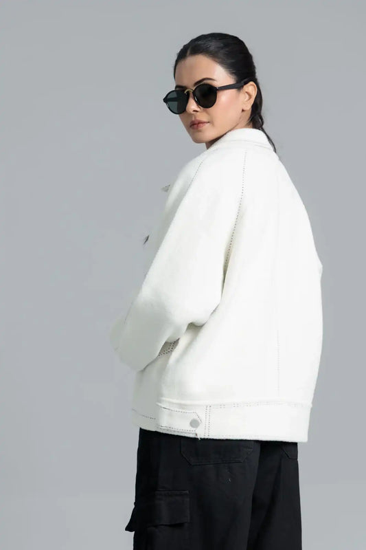 Model wearing a white jacket and black pants 