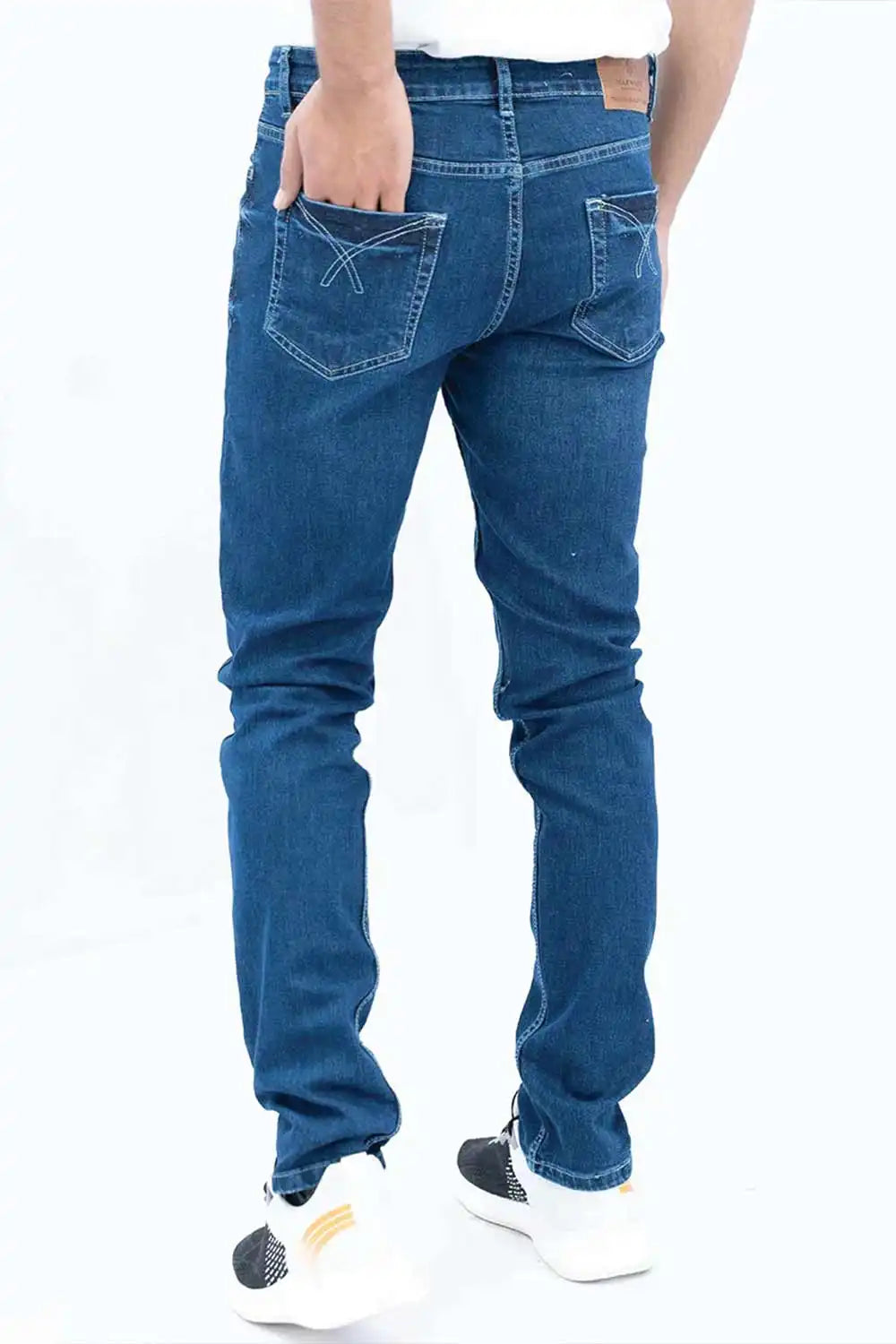 Person wearing blue jeans on a white background