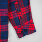 Close-up of multi-color shirt sleeve cuff with red and blue checks