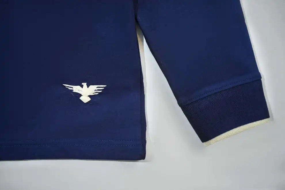 Navy blue shirt with a white logo on a light gray background