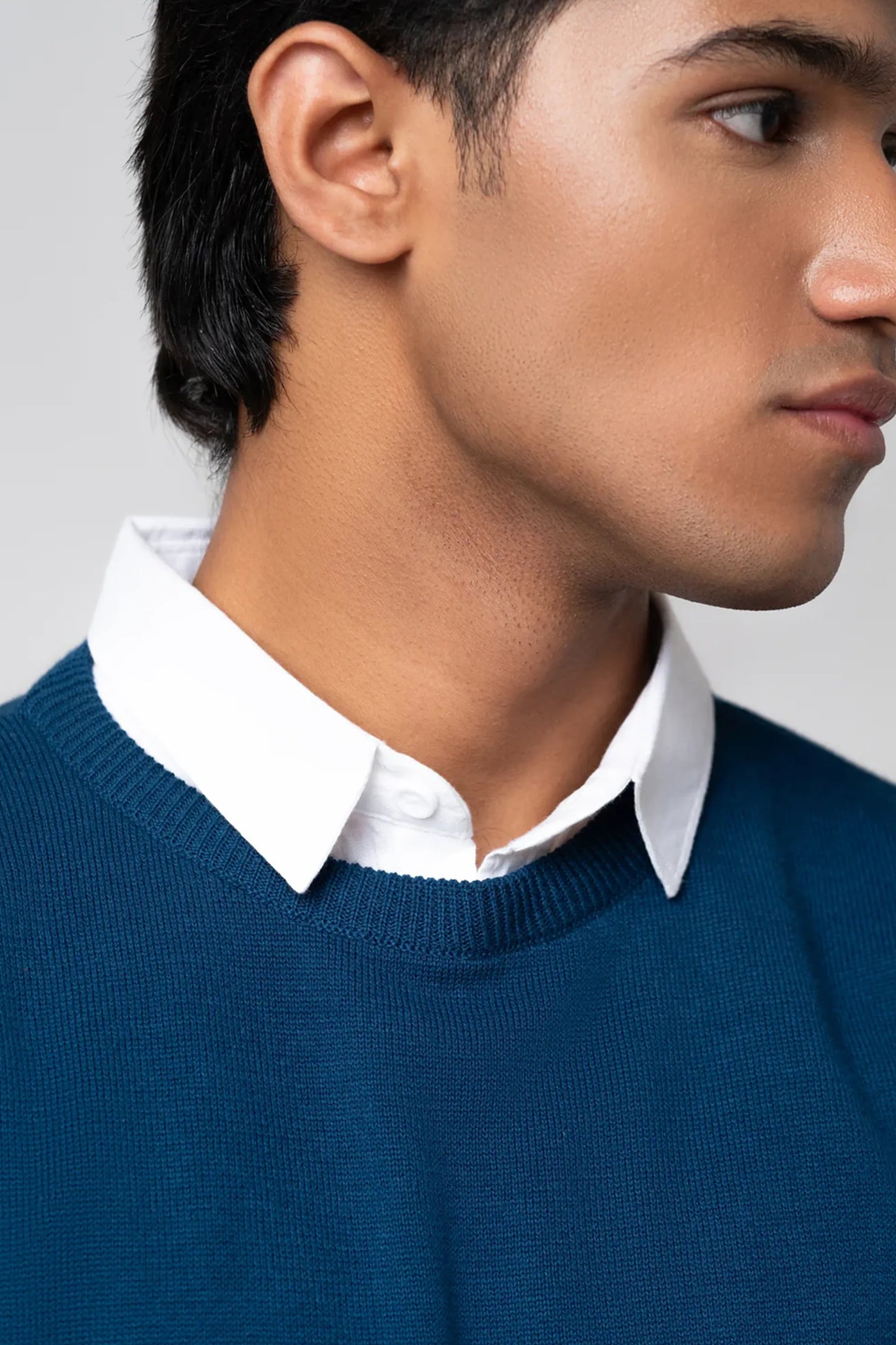 Neck and collar close-up highlighting crew neck sweater navy