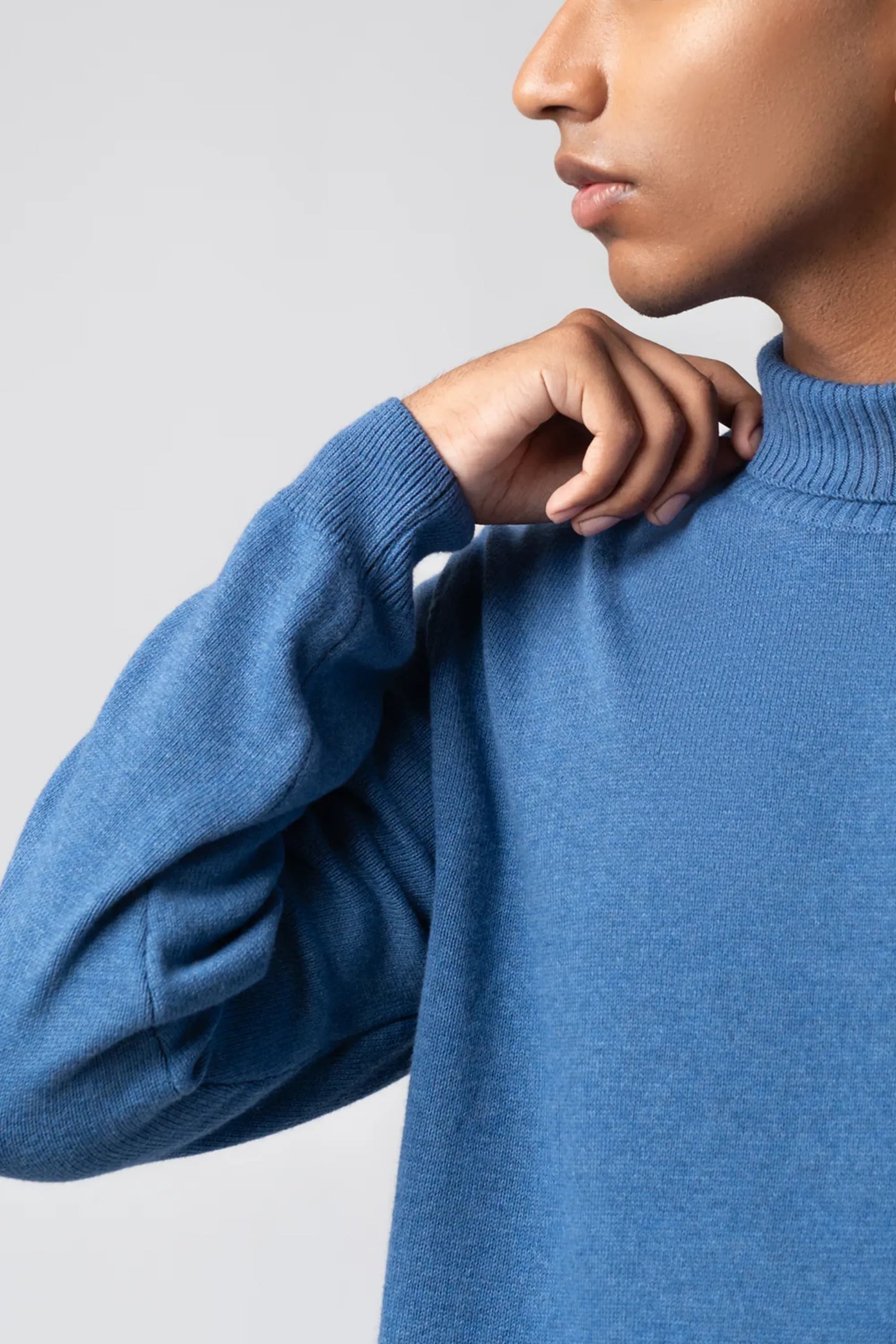 Neckline close-up highlighting turtle neck sweater navy