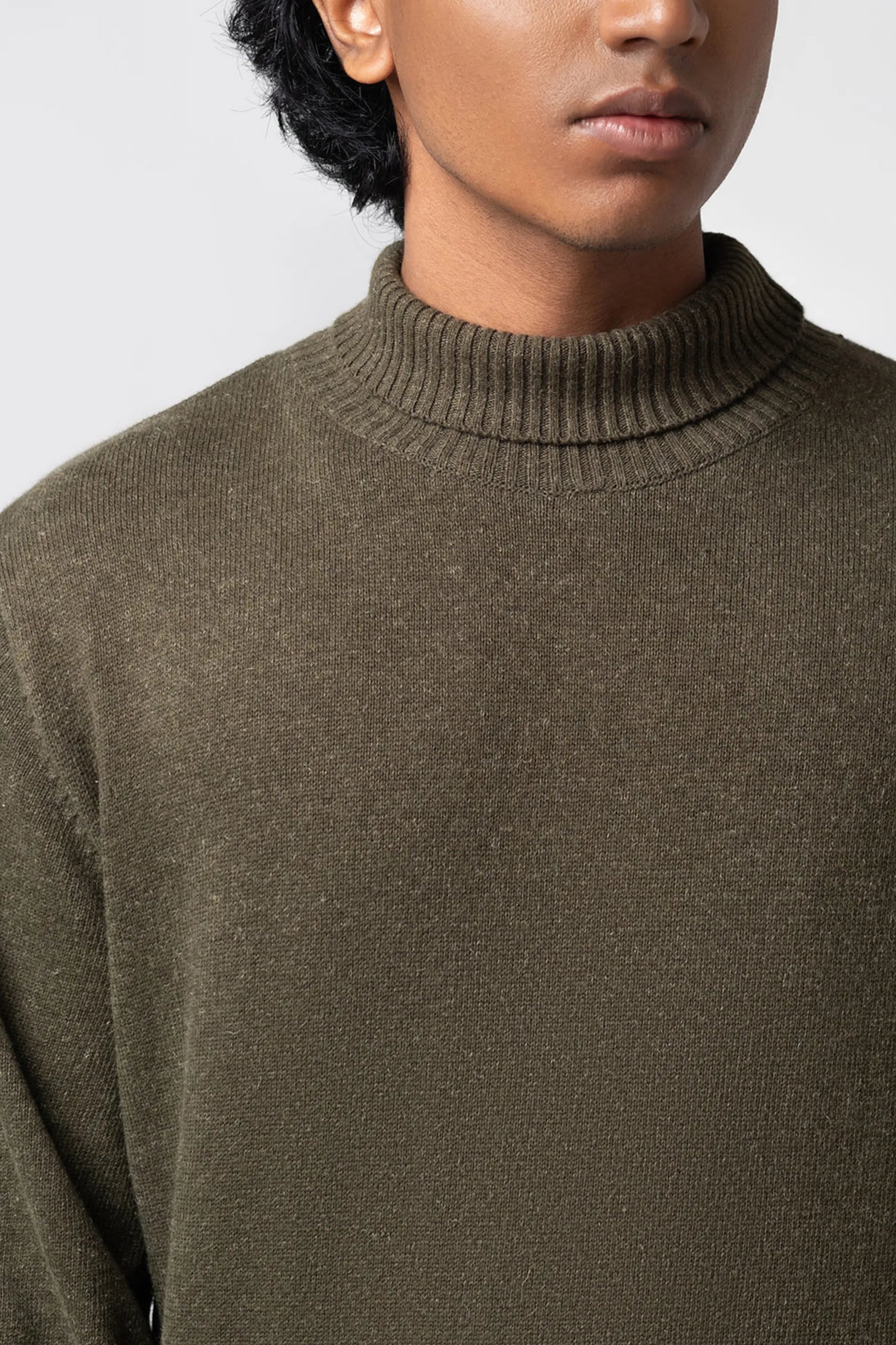 Neckline close-up highlighting turtle neck sweater olive texture