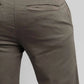 Close-up of olive green pants on a plain background