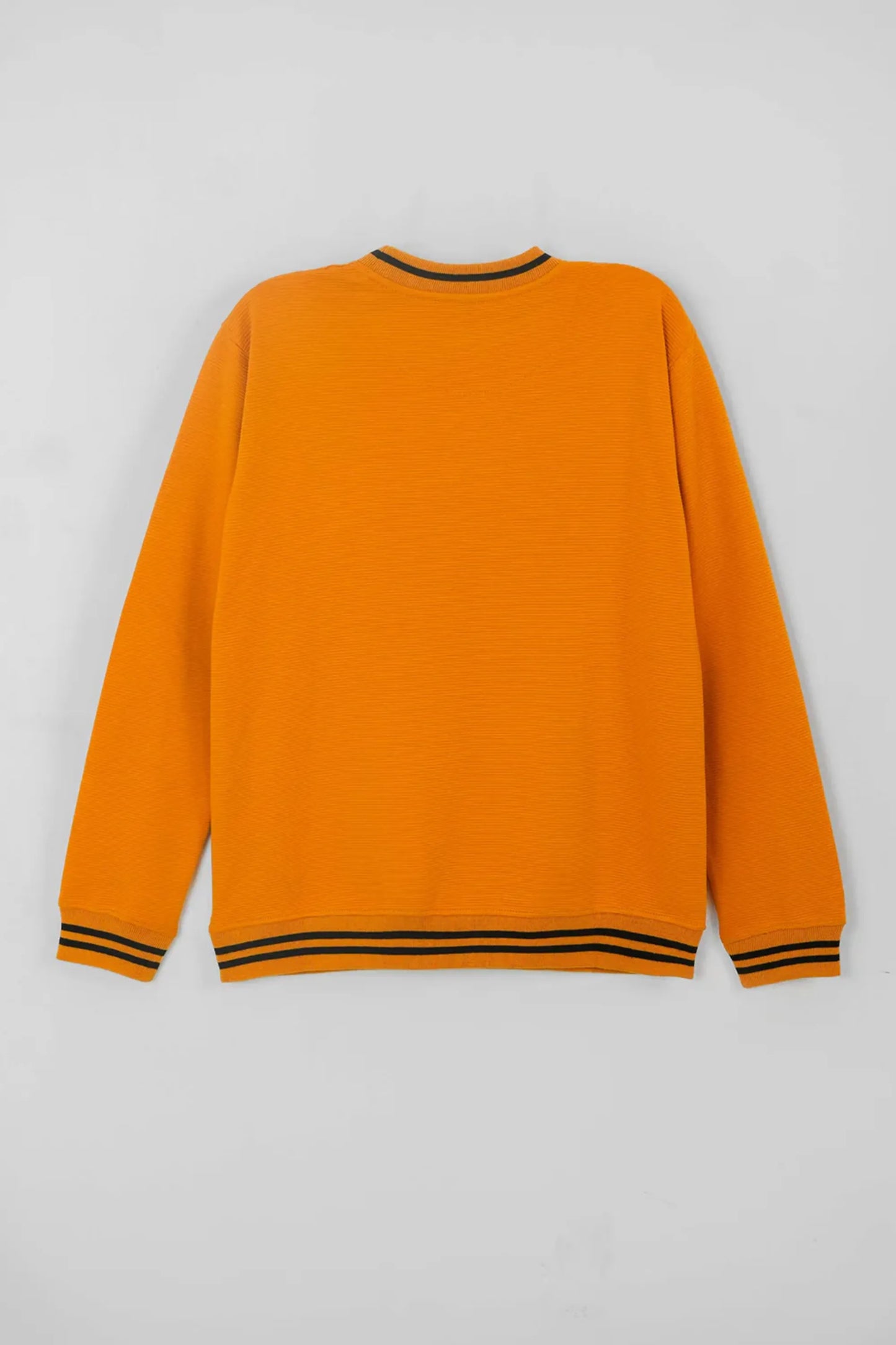 Orange sweater with black trim on a light gray background