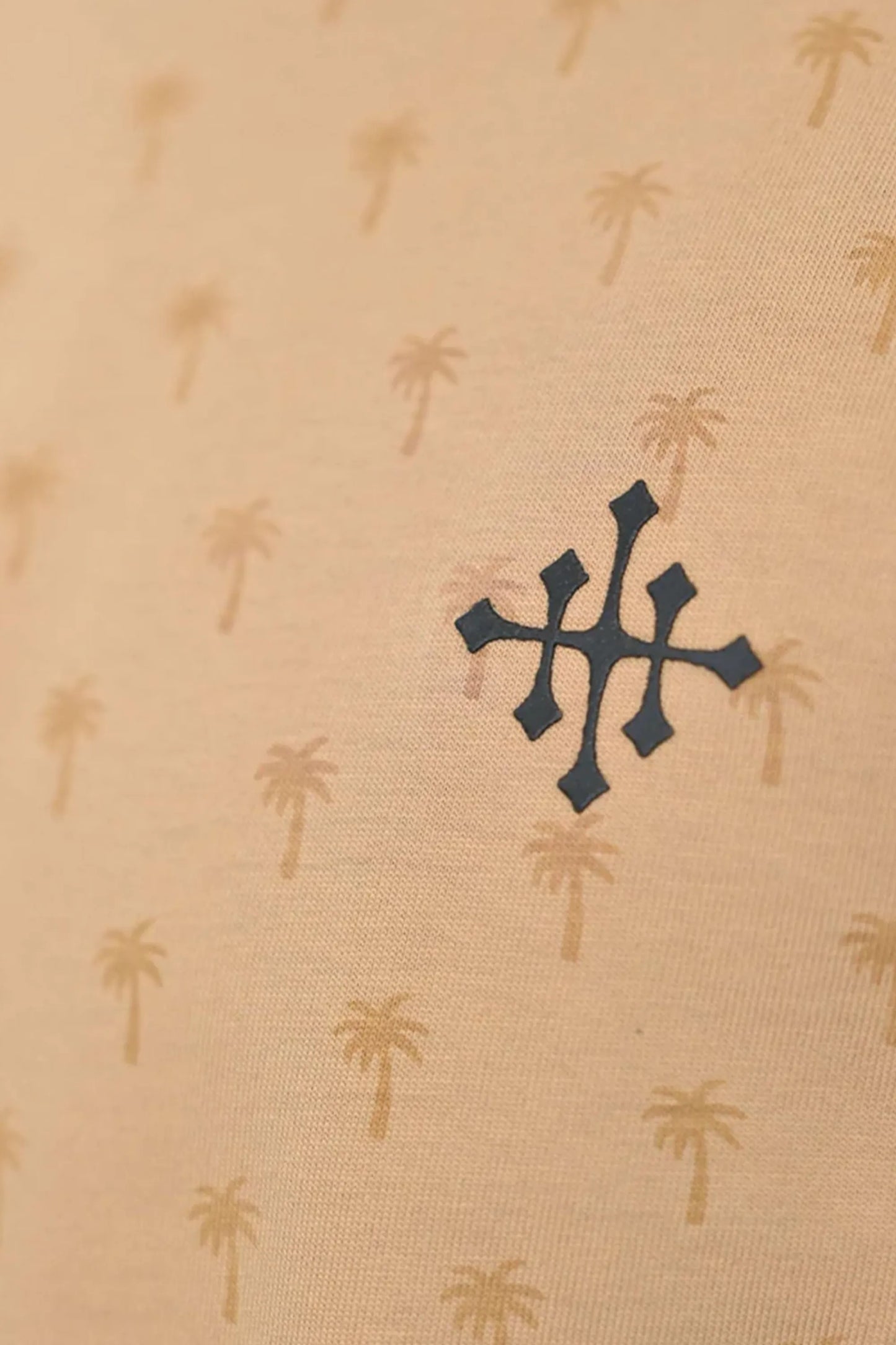 Pattern close-up displaying palm rotatory design on beige fabric