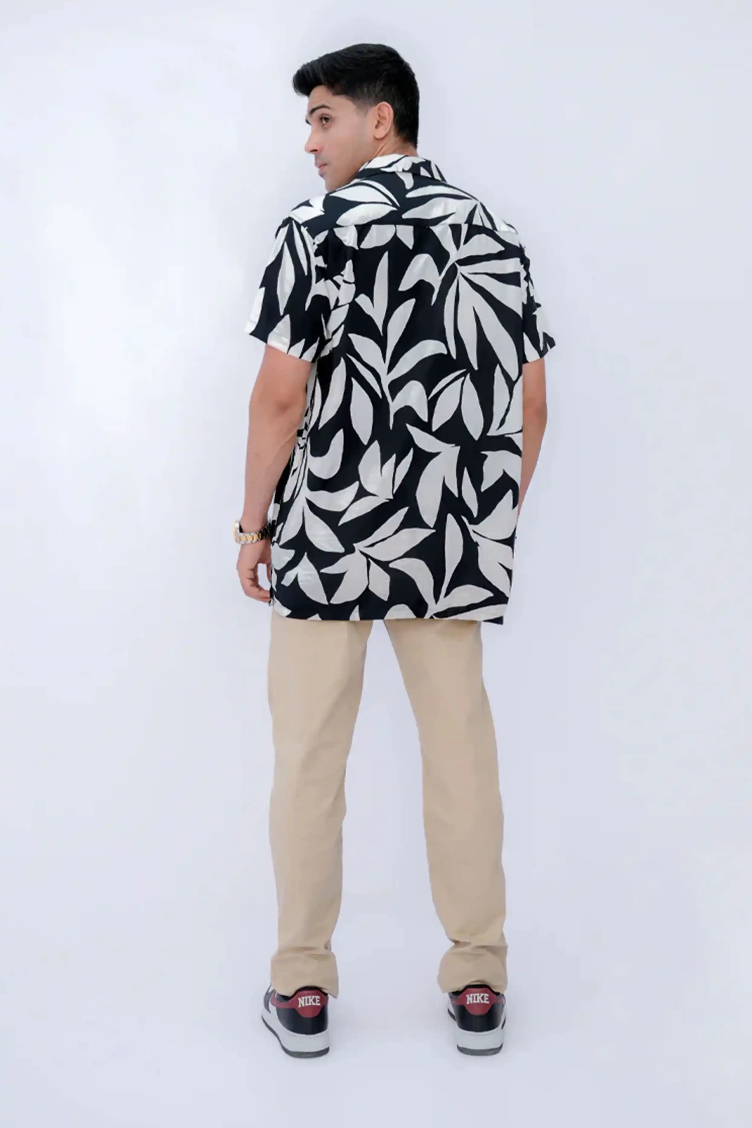 Person wearing a black and white patterned shirt