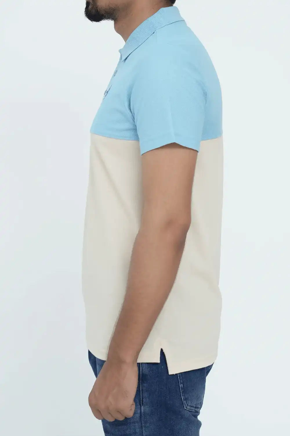 Person wearing a light blue and beige color-blocked polo shirt 