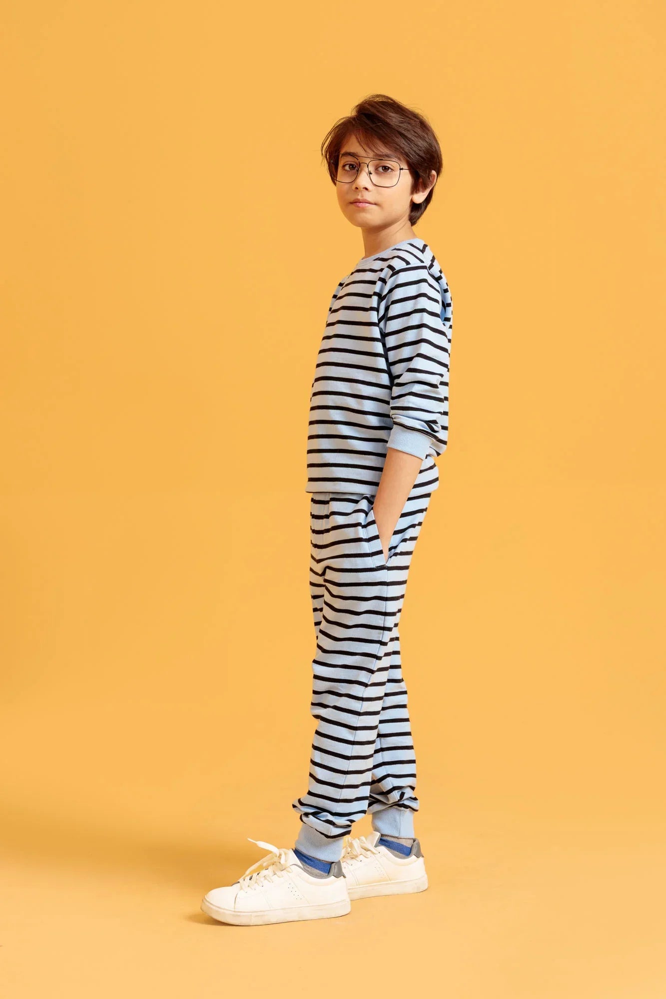 Person wearing a striped outfit on an orange background