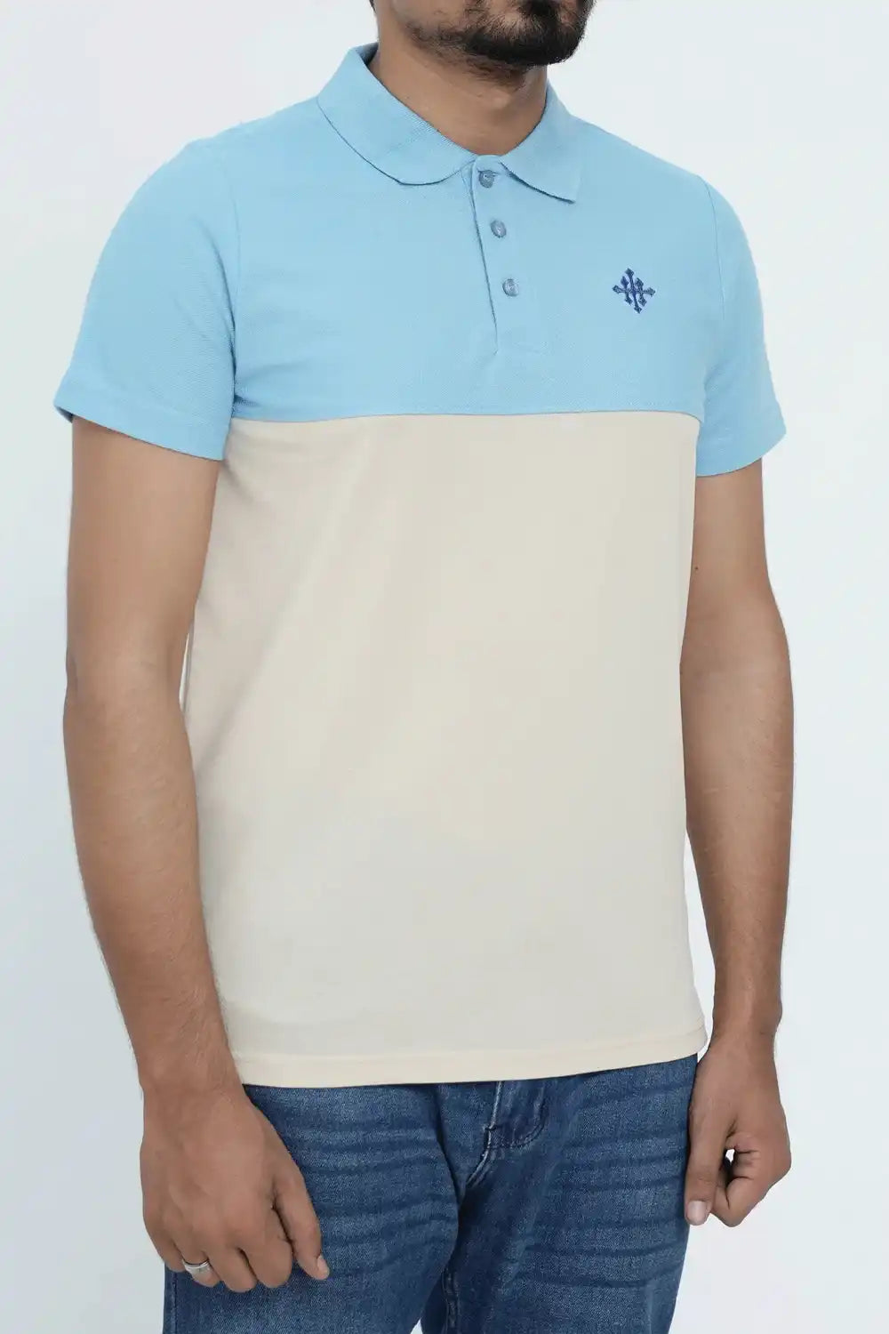 Person wearing a two-tone blue and beige polo shirt