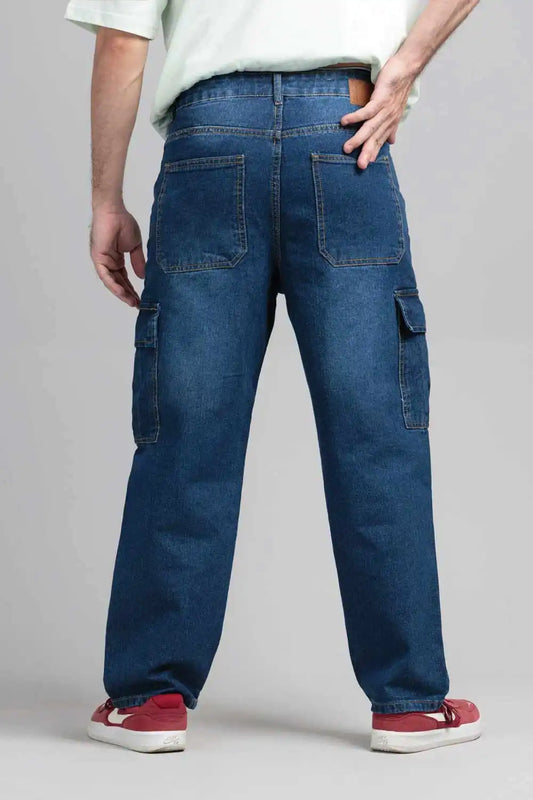 Person wearing blue cargo pants on a plain background