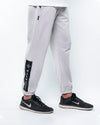 Men’s quiet grey trousers with contrast trims