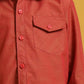Red button-up shirt with a pocket on a yellow background