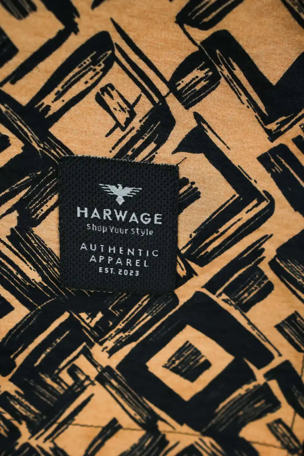 Shirt with a black geometric pattern and the Harwage brand label
