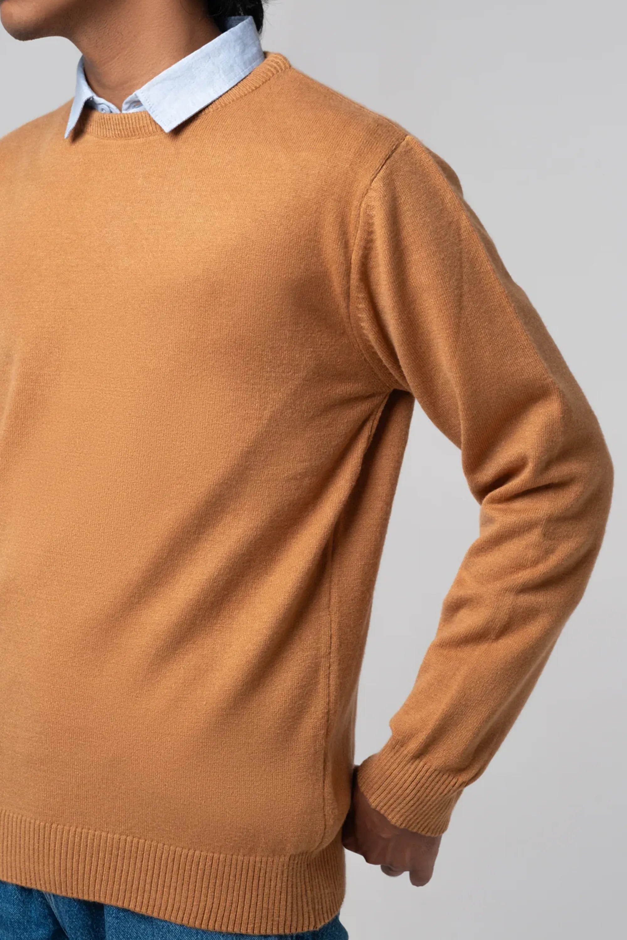 Side angle highlighting fit of crew neck sweater mustard